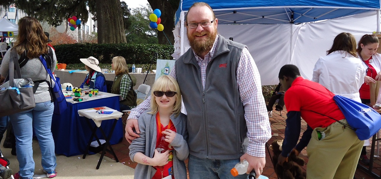DBS Client Emma Kever and her dad Matthew Kever smiling amidst the Children's Day festivities