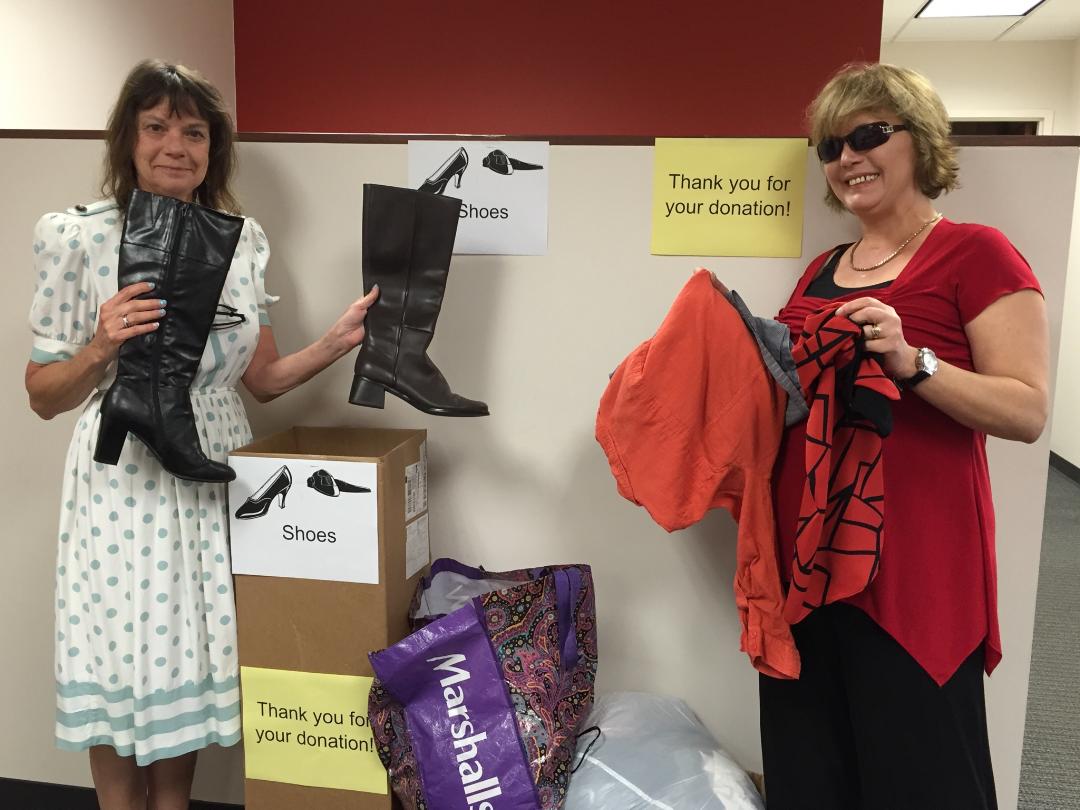 Lynne Taylor- Rehabilitation Technician and VR Counselor Darlene Acree hold up donated items from the Lakeland office.