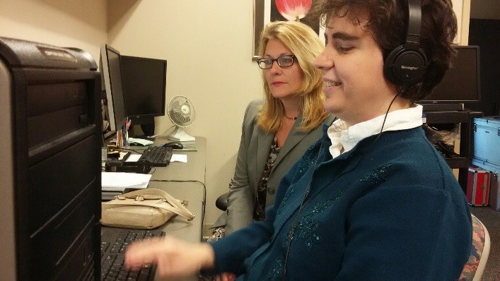 Client Anastasta Charalambakos working at a computer with St. Petersburg College Accessibility Services Director Aimee Stubbs.