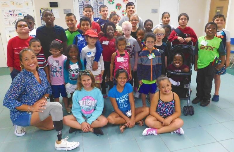 Paralympian Natalie Bieule with a class of nearly 30 boys and girls at the Miami Lighthouse.