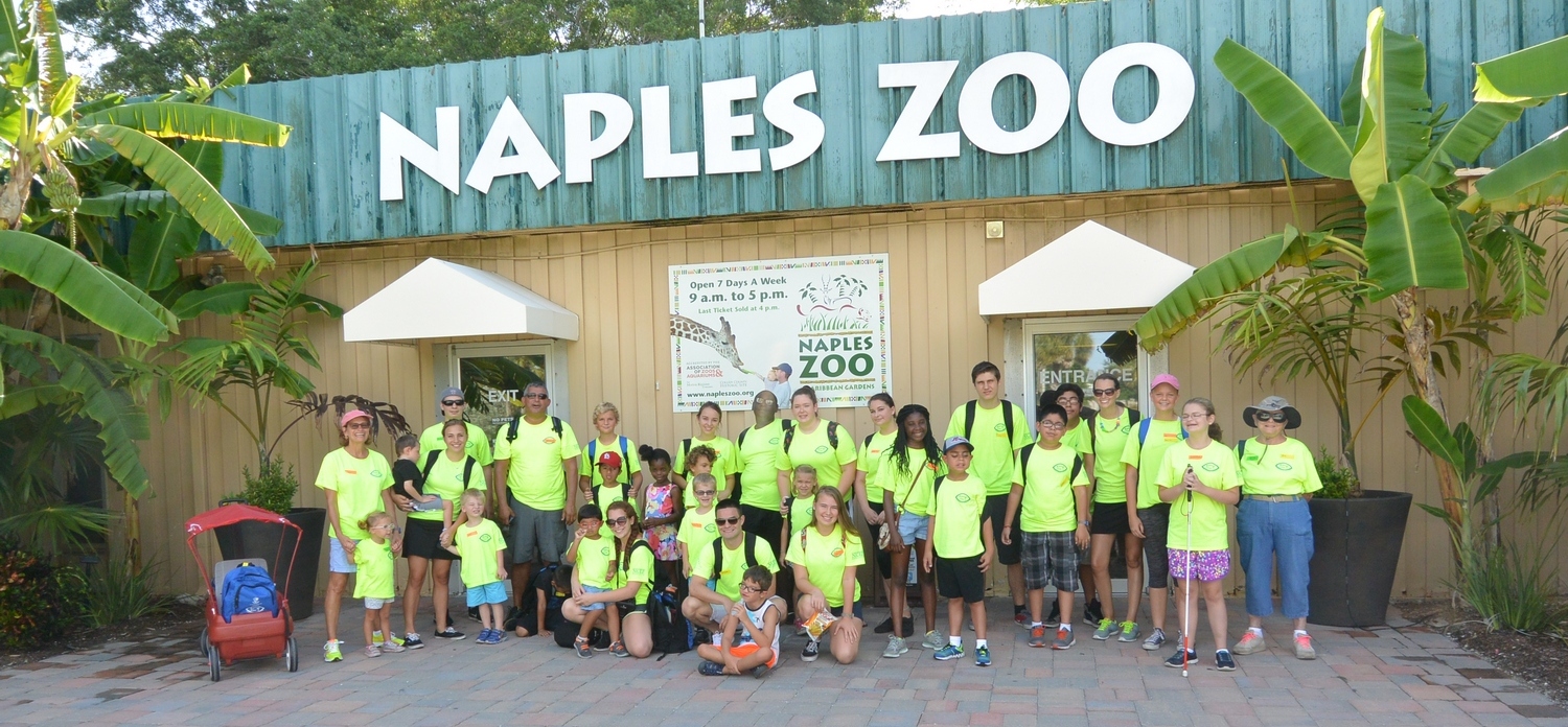 Lighthouse of Collier summer campers are wearing lime green shirts while standing outside the Naples Zoo. 