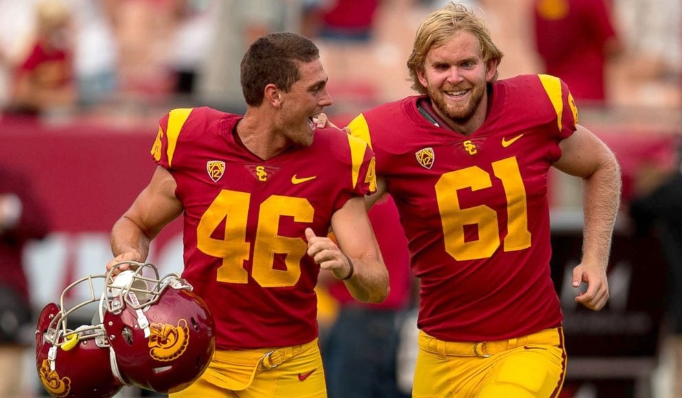University of Southern California Jake Olson being guided unto the football field by his teammate. 