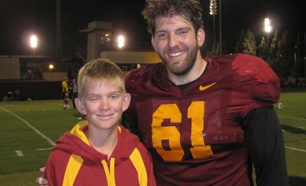 Jake Olson at the age of 12 with a then-USC football player. 