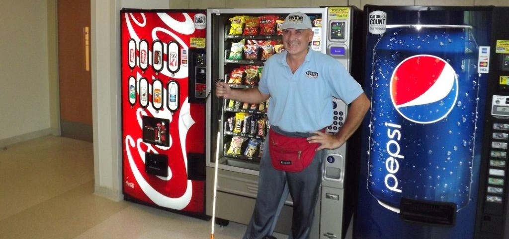 man standing by vending machines.