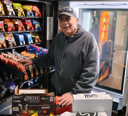 BEP facility operator loading a vending machine.