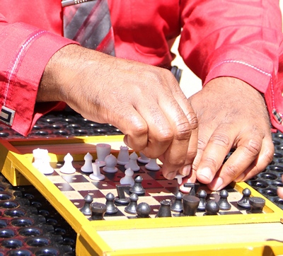 Walter Blackmon examining a tactile chess set.