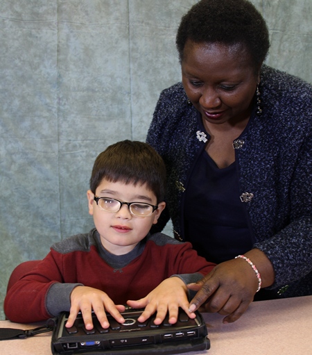 Boy using a Braille note taker.