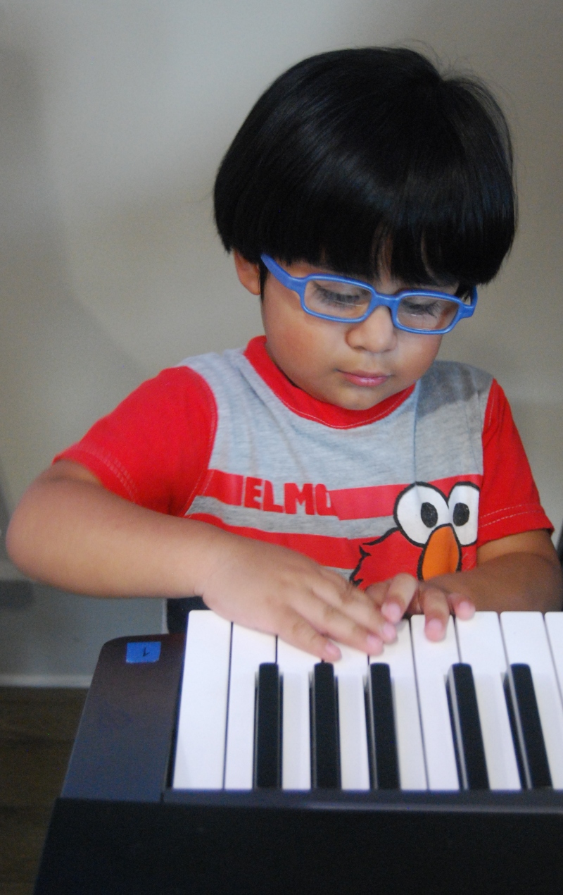 Toddler Alex playing music on the keyboard 