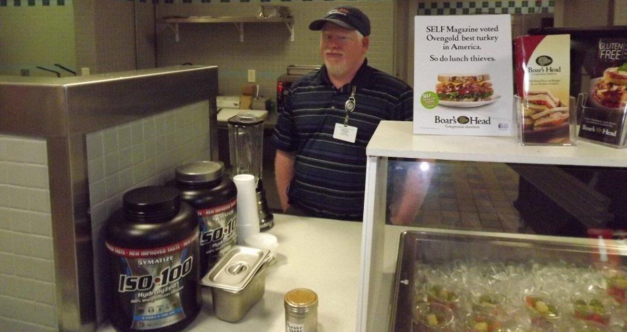 Joe Bragg standing behind a service counter