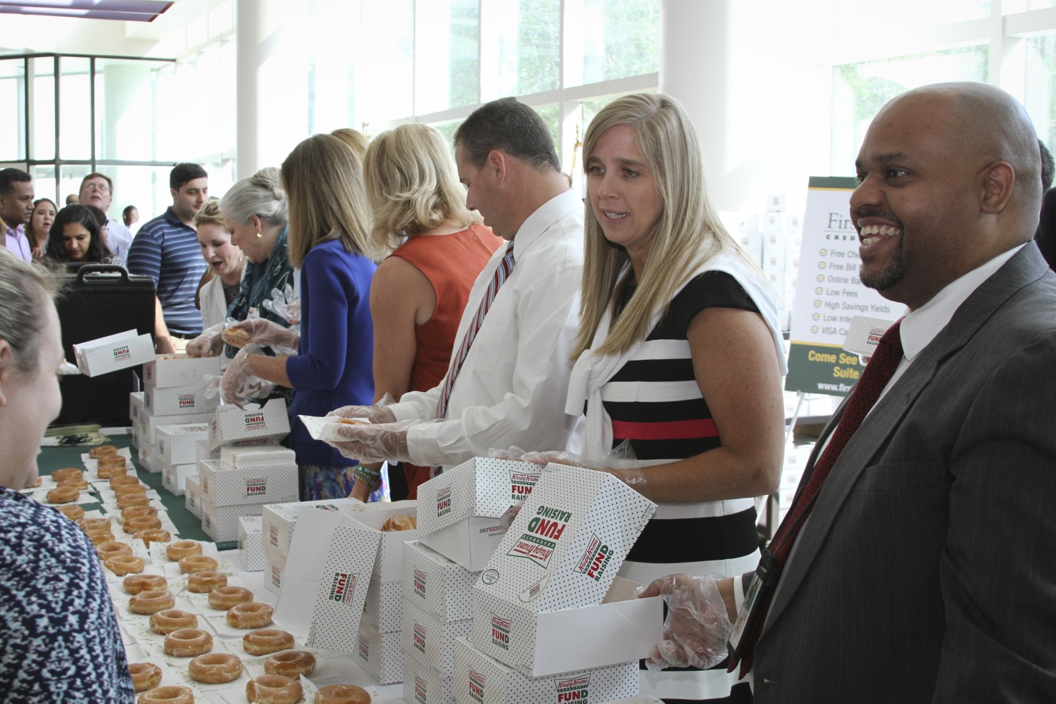 Director Doyle serving donuts with other members of the FDOE leadership team