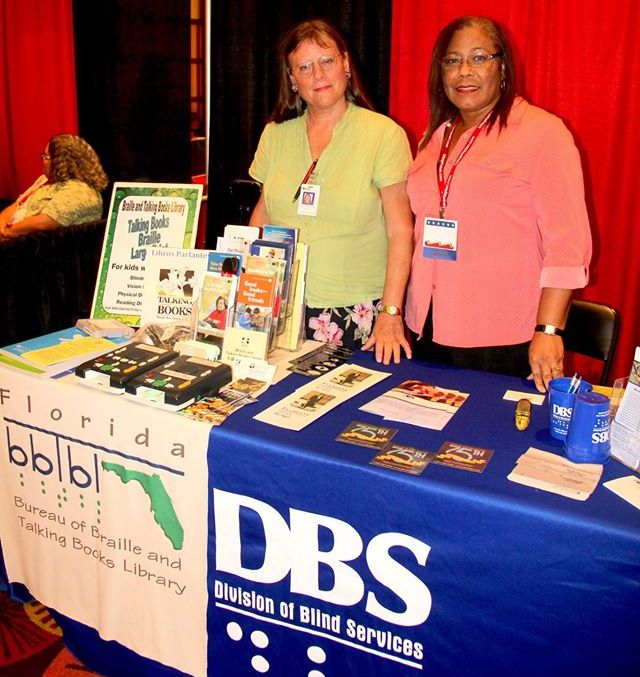 DBS staff at exhibit table in cafe