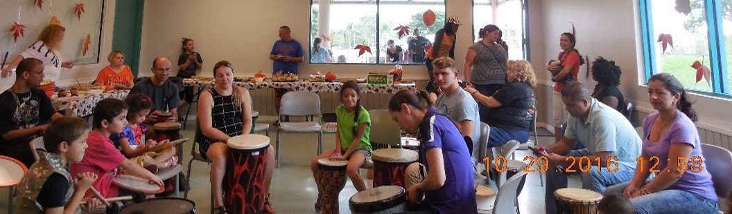 Guests participate in a drum circle