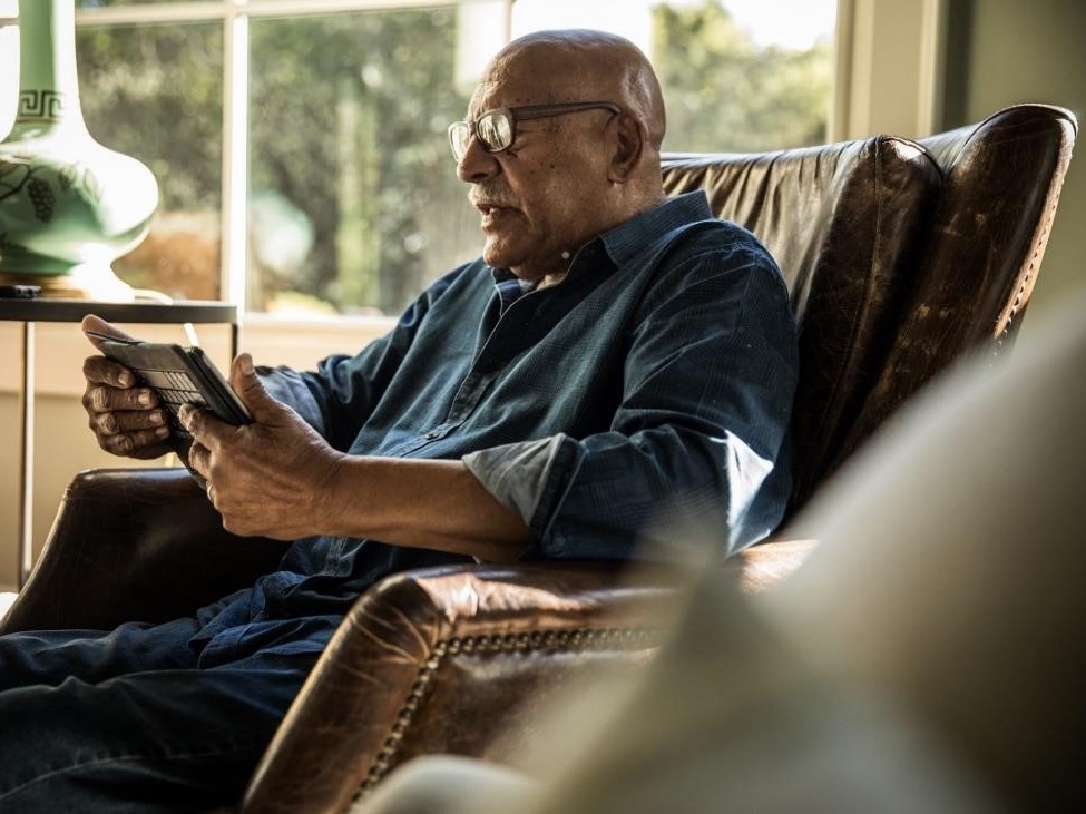 Older man reading a book.