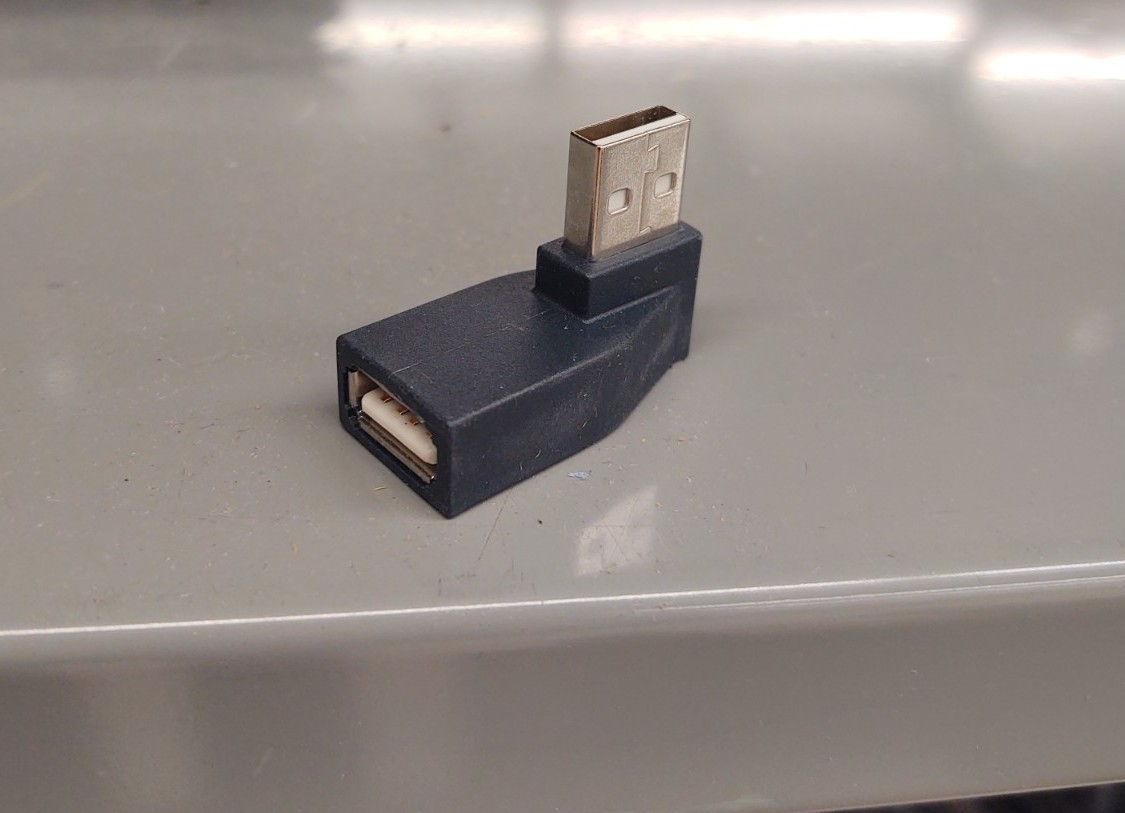 Close up view of right angle USB thumb drive adapter (AC020).