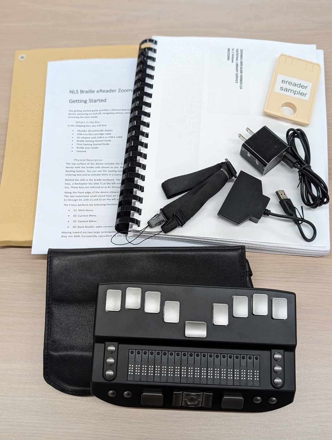 Close up view of Zoomax  braille eReader (EBZ) and accessories.