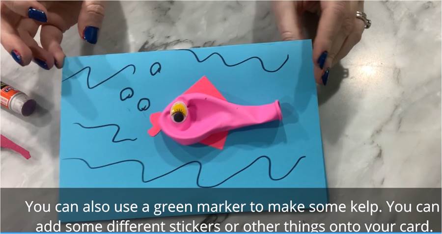 A greeting card that has a (uninflated) balloon on the front and decorations around it that looks and feels like a fish!